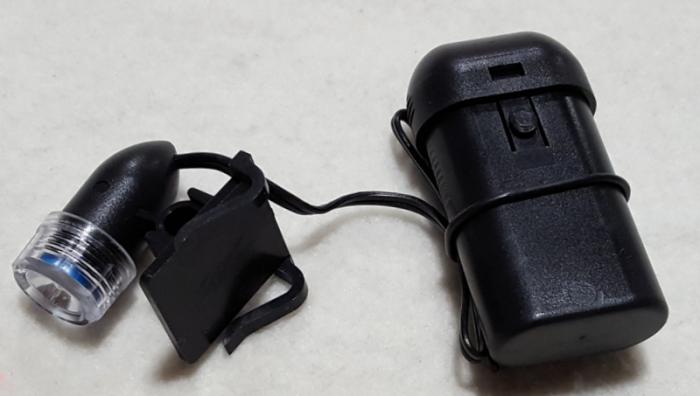  alt="VisorLight illuminates the OptiVisor's magnified viewing area. You get 6000 candlepower and 5-6 hour battery life. Takes AA batteries."